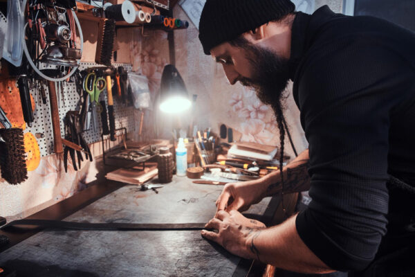in-the-busy-workshop-talented-master-is-making-his-masterpeace-from-leather